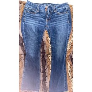 dark-washed boot cut jeans.